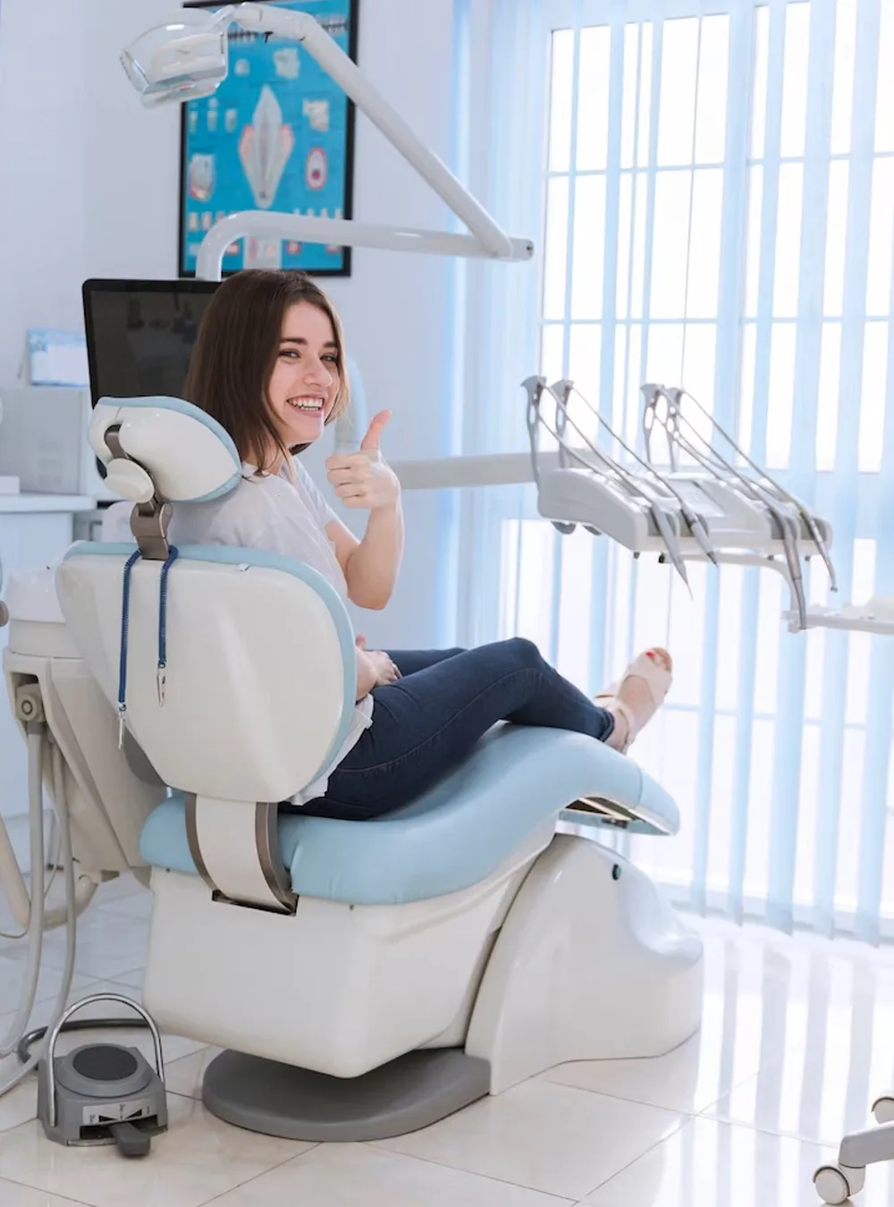 Patient giving a thumbs up from the dental chair after treatment