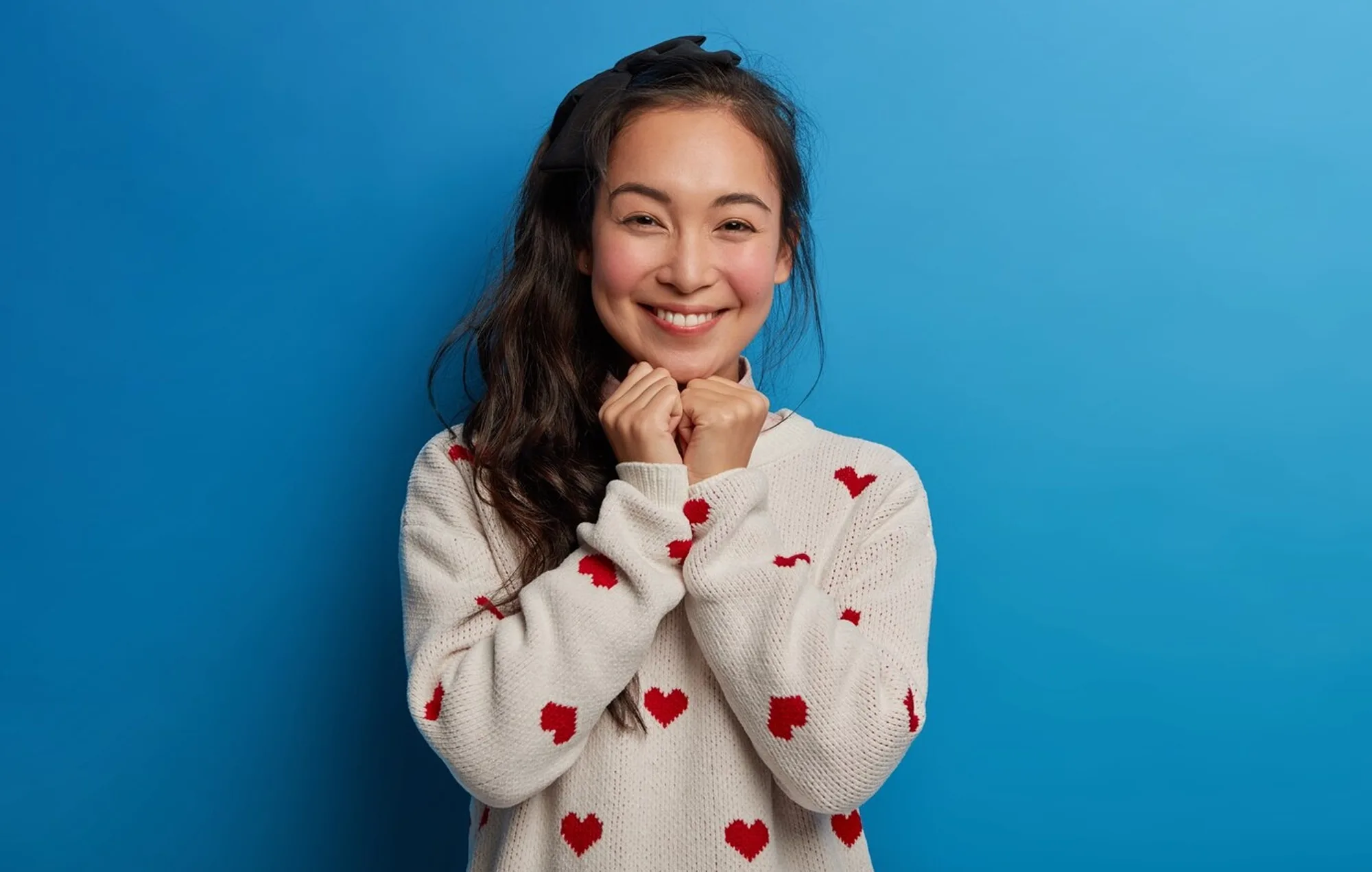 Smiling woman with healthy teeth against a blue background